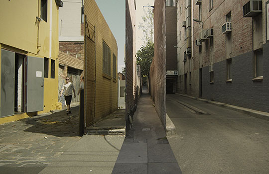 A person walking in an ally in an urban setting