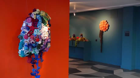 Crochet coral reef sculptures installed in gallery.