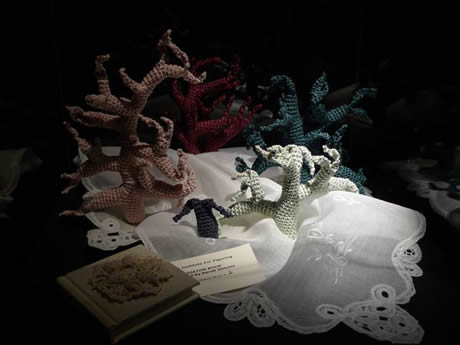 Lace doilies as part of installation in darkened gallery