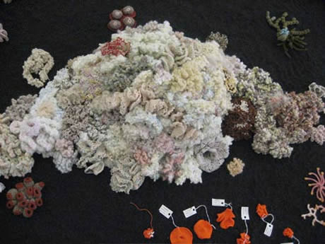 Detail of crochet coral reef sculpture on floor.