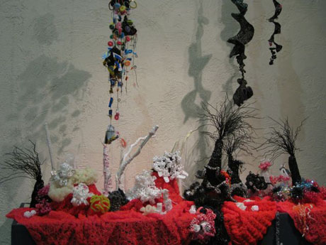 Detail of crochet coral reef sculptures installed on plinth in gallery.