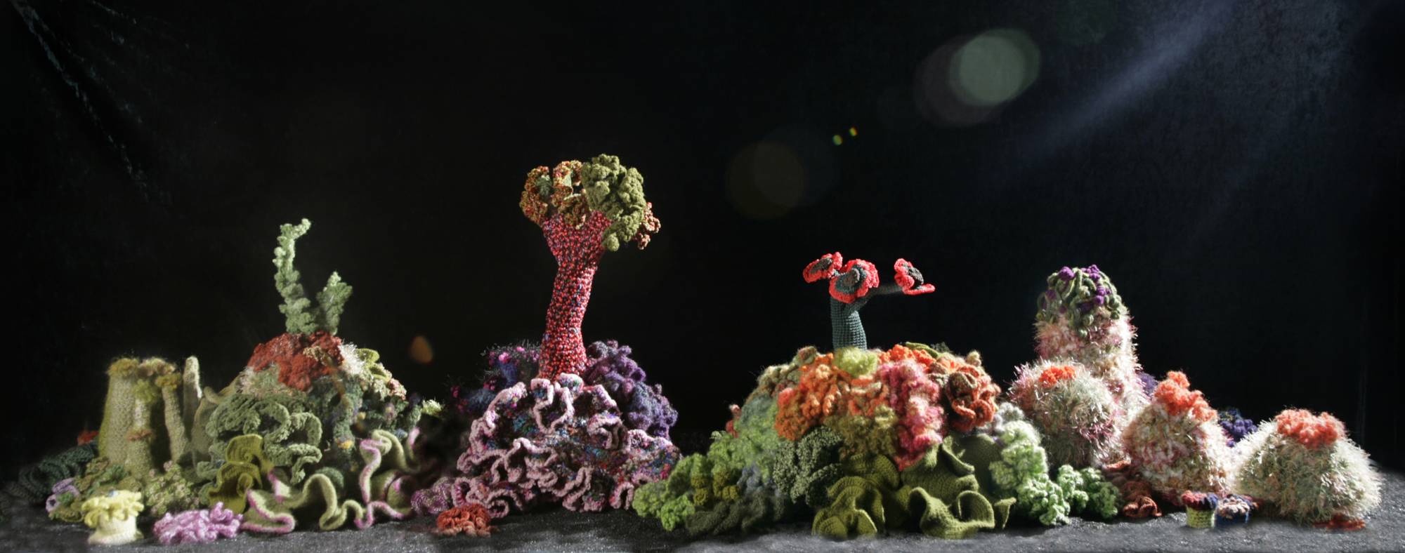 Coral sculpture landscape in greens and reds and purple
