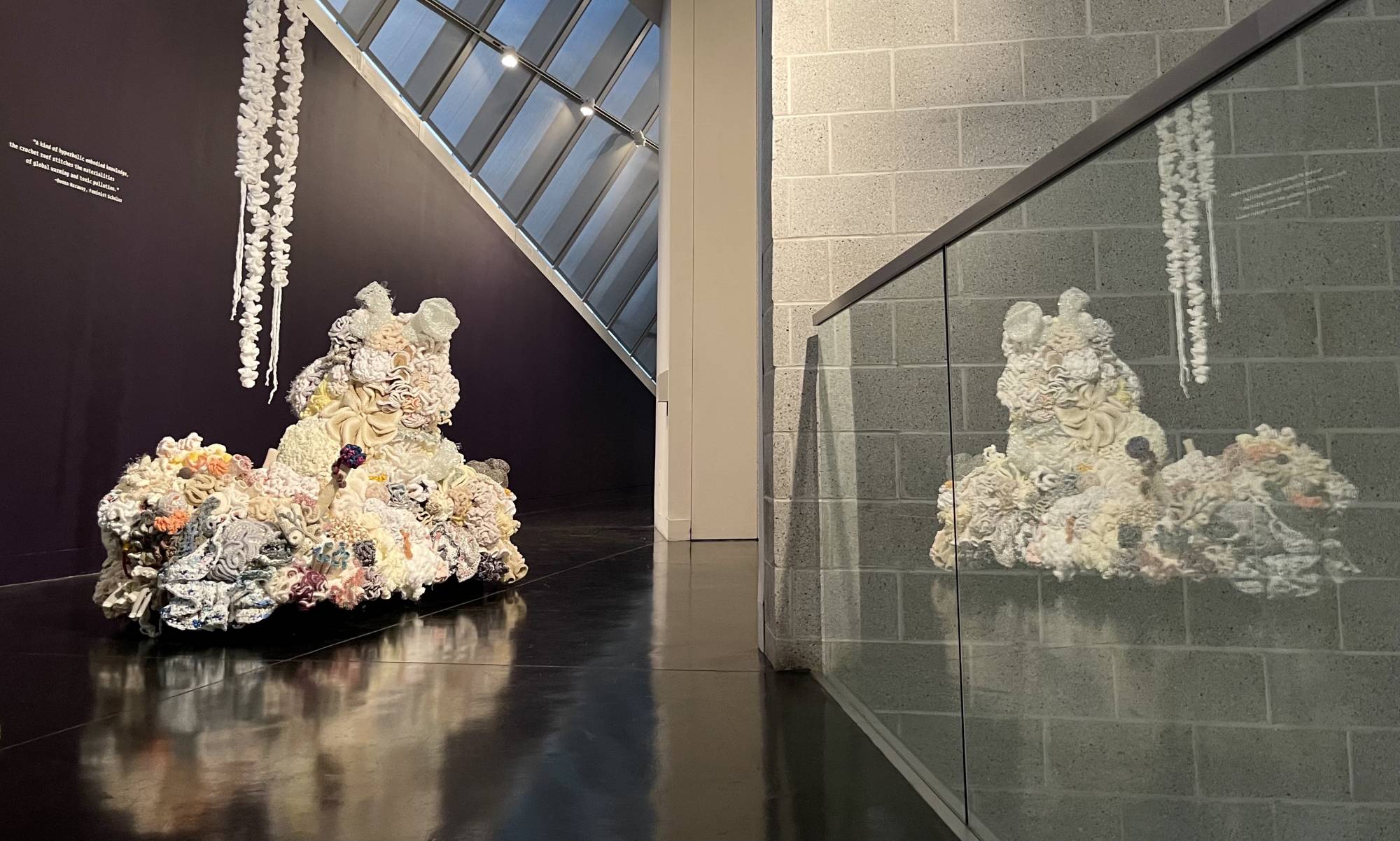 Island of white crochet corals win museum with reflections in glass